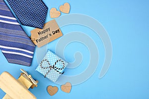 Happy Fathers Day gift tag with side border of gifts, ties and hearts on a blue background