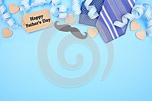 Happy Fathers Day gift tag with top border of gifts, decor, ties and ribbon on a blue background