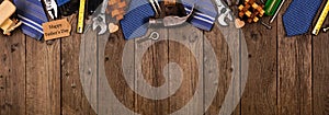 Happy Fathers Day gift tag with top border of gifts, ties and tools on a wood banner background