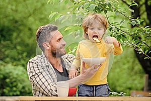 happy fathers day. Little boy with dad eat cereal. father and son eating outdoor. Morning breakfast. Vegetarian diet