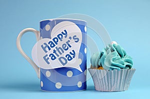 Happy Fathers Day message on blue theme polka dot coffee mug with cupcake.