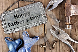 Happy Fathers Day metal sign with tools and ties on wood