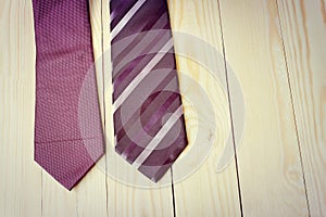 Happy Fathers Day with red, gray and black striped necktie on pine wood background in vintage style