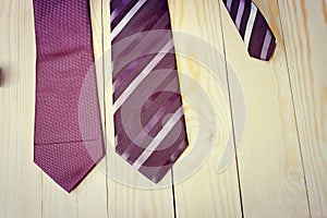 Happy Fathers Day with red, gray and black striped necktie on pine wood background in vintage style