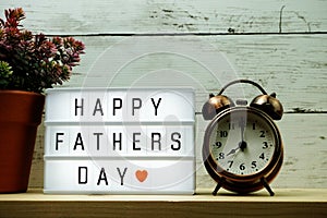Happy Fathers Day Text on light box and alarm clock