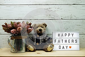 Happy Fathers Day word on light box with teddy bear