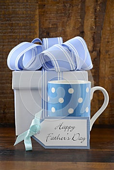 Happy Fathers Gift with blue and white gift on wood background.