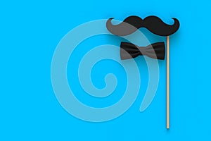 Happy Fatherâ€™s Day concept with mustache and bow tie on blue background, Top view with copy space