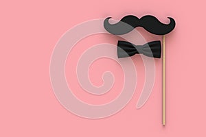 Happy Fatherâ€™s Day concept with mustache and bow tie on pink background, Top view with copy space.