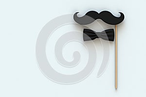 Happy Fatherâ€™s Day concept with mustache and bow tie on white background, Top view with copy space