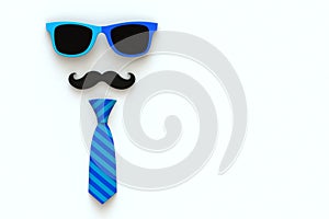 Happy Fatherâ€™s Day concept with neck tie, mustache and glasses on white background, Top view with copy space