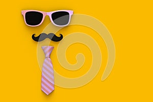 Happy Fatherâ€™s Day concept with neck tie, mustache and glasses on yellow background, Top view with copy space