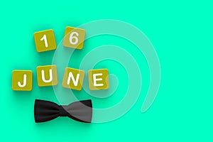 Happy Fatherâ€™s Day message with bow tie on green background, Top view with copy space