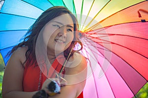 Happy fatty woman with umbrella