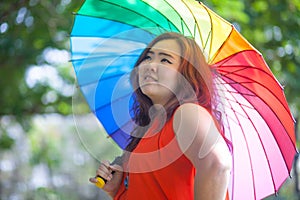 Happy fatty woman with umbrella