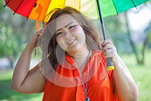 Happy fatty woman with umbrella