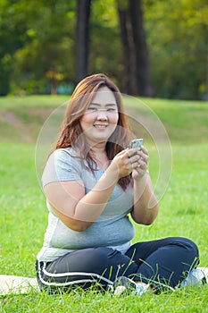 Happy fatty woman using mobile phone