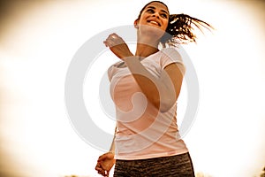 Happy and feel good running at sunny day. Young woman.