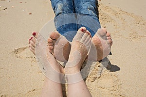 happy feet on the beach touching together, loving foot