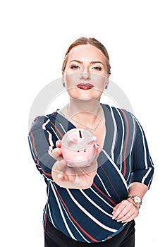 happy female accountant giving pink piggy bank