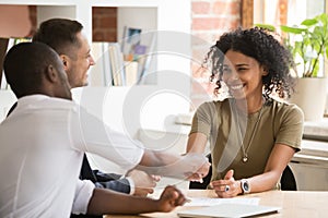 Happy female african vacancy candidate shaking hand of hr manager