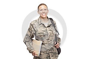 Happy female airman with books and bags