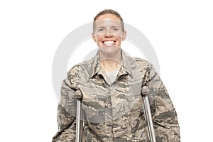 Happy female airman on crutches photo