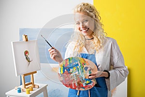 Happy female artist painting