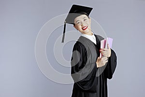 happy female asian graduate student against grey