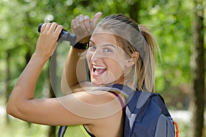happy female birdwatcher shows thumbs up