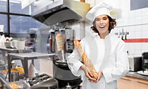 Happy female chef with french bread or baguette