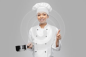 happy female chef with saucepan showing thumbs up