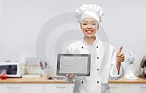 happy female chef with tablet pc showing thumbs up