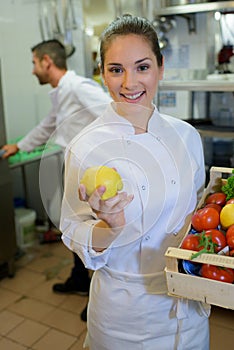 happy female chef with vegetables
