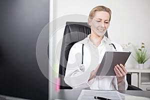 Happy Female Clinician Using her Tablet Computer