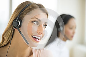 Happy Female Customer Service Representative Looking Away