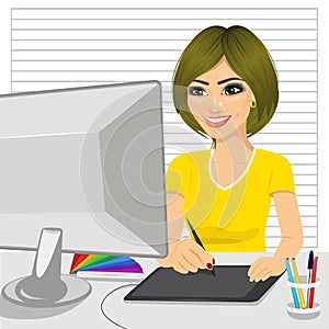 Happy female designer in office working with digital graphic tablet and digital pen