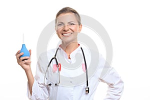 Happy female doctor holding enema