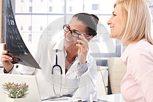 Happy female doctor at medical office with patient