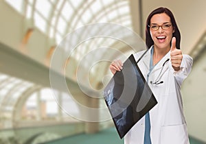 Happy Female Doctor or Nurse Holding X-ray Inside Hospital.