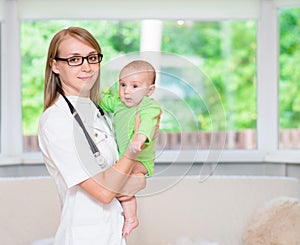 Happy female doctor pediatrician and patient child baby