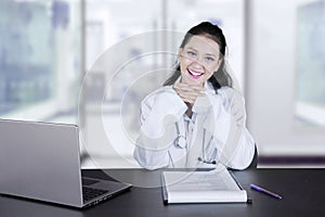 Happy female doctor working in the clinic