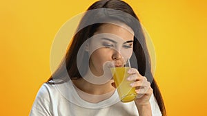 Happy female drinking fresh orange juice at cafe, vitaminized energetic beverage