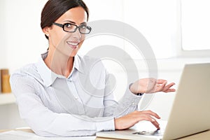 Happy female employee using the computer