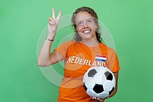 Happy female football fan from Holland with orange jersey