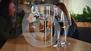 happy female friend company celebrate and drink red and white wine in restaurant