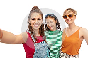 Happy female friends in sunglasses taking selfie