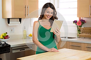 Happy female on her watching videos on her tablet computer while relaxing at home with perfect smile