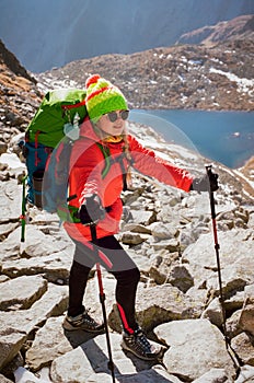 Happy female hiker on mountain top enjoys Popradske pleso