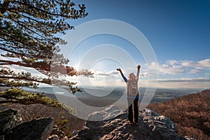 Happy female hikerat the summit of an Appalachian mountain